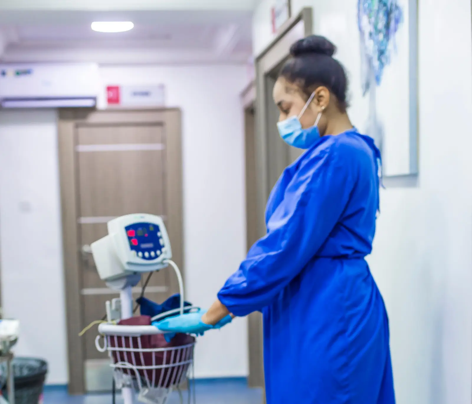 A Cardiocare nurse preparing monitored clinical equipment